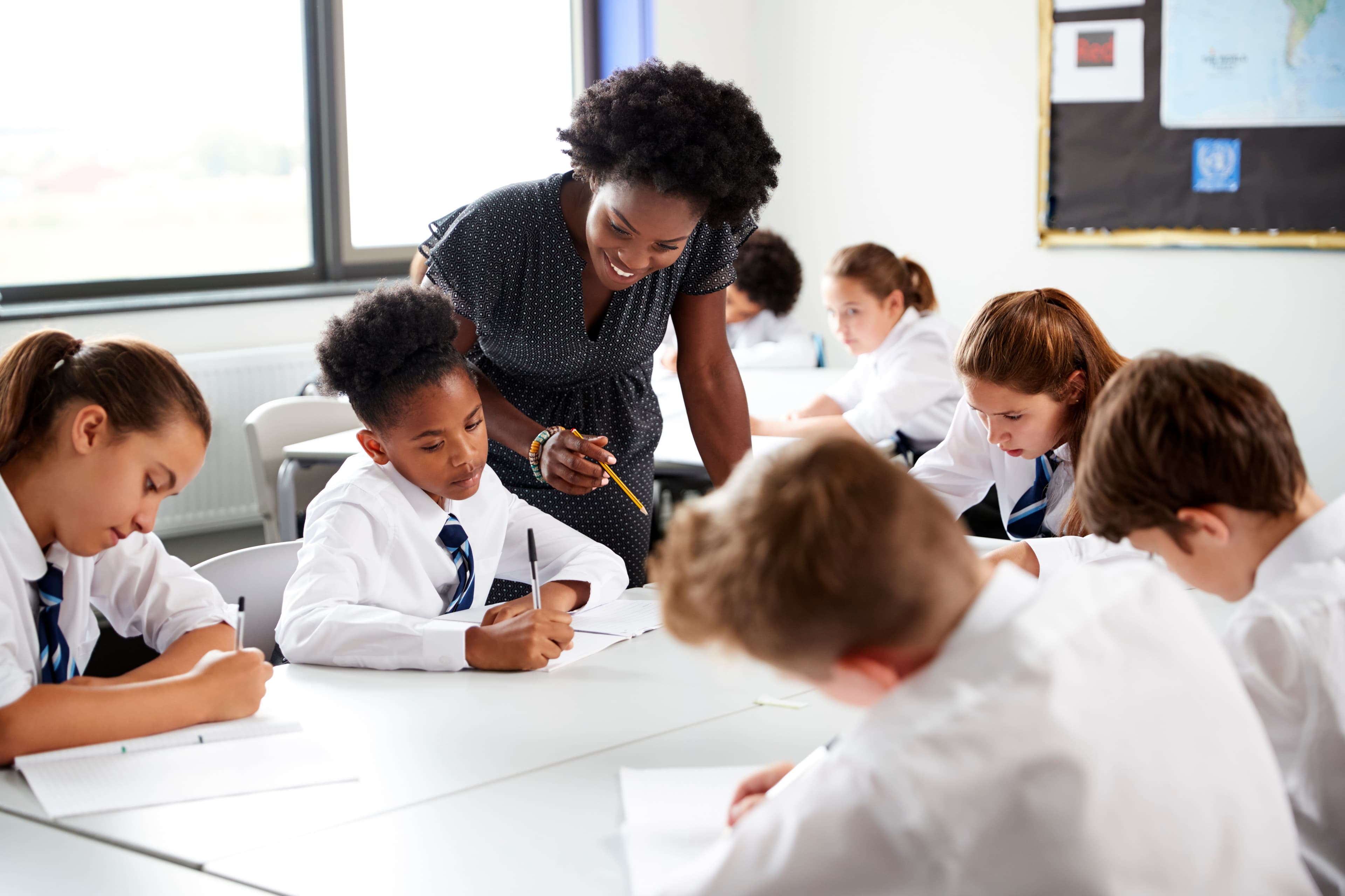 Teacher helping students